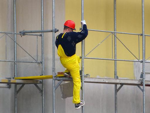 Man climbs scaffolding