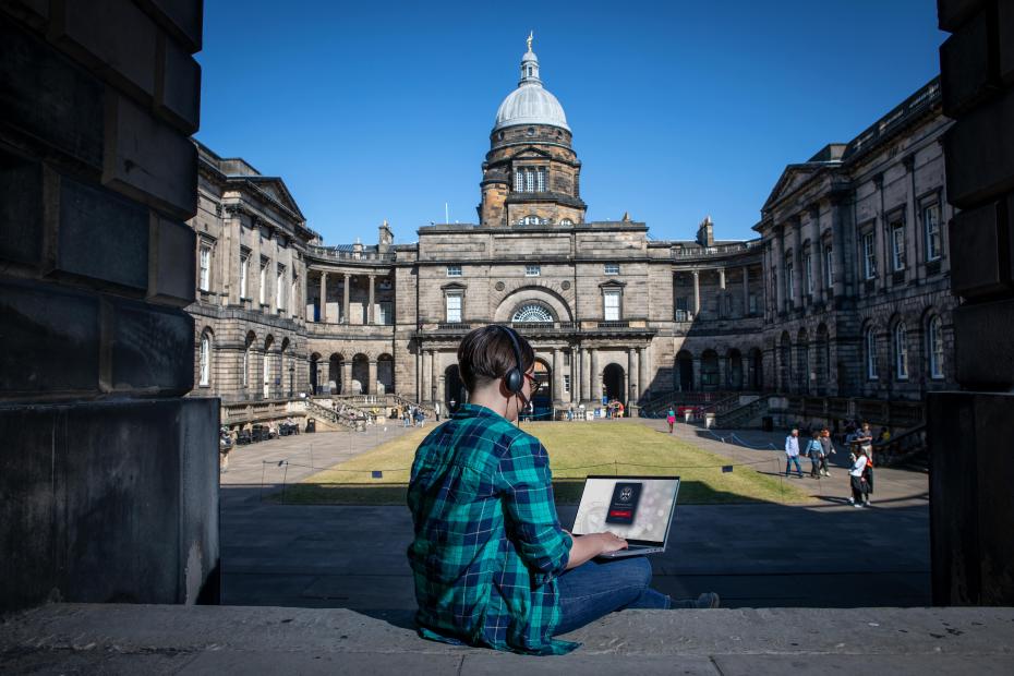 Student working on a laptop outside