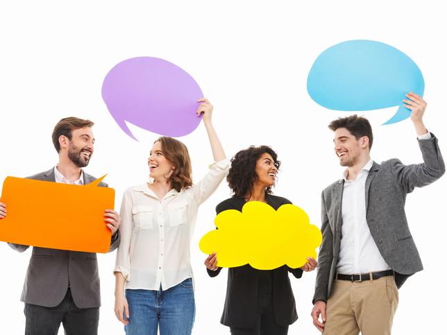 Group of four multi-racial people holding speech balloons