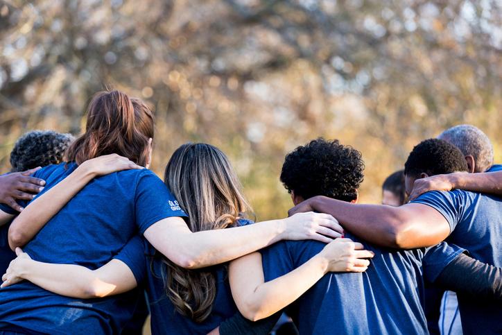 group of young people with arms around each other