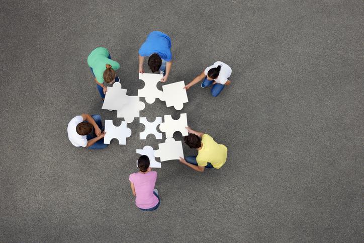 A group of people put together a giant jigsaw