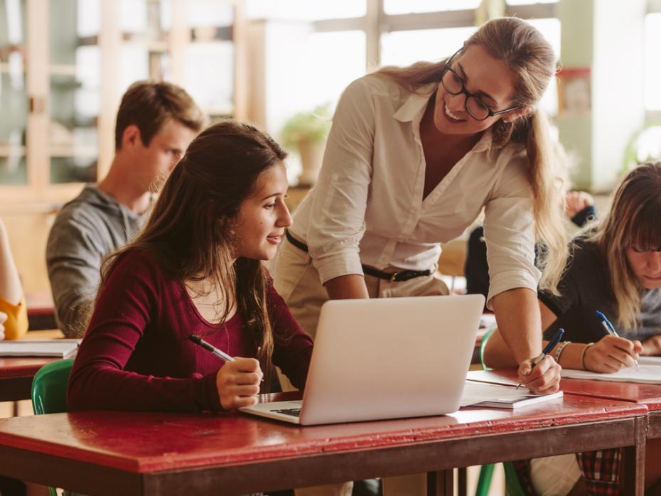 Student and teacher interacting in a classroom