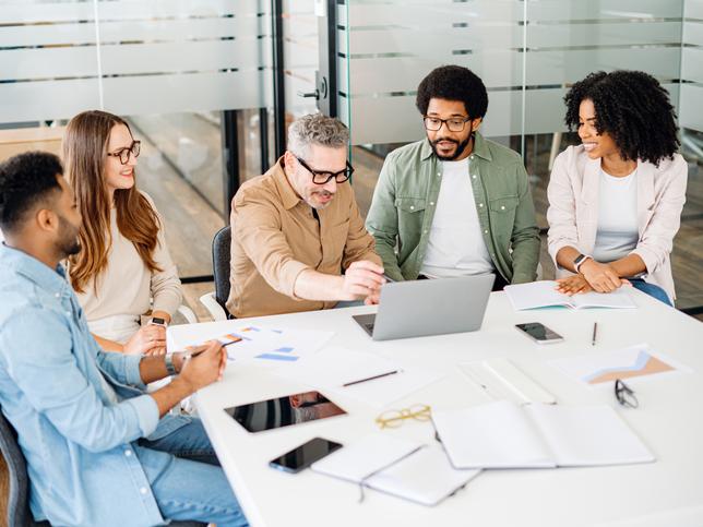 A group of people work around an office table