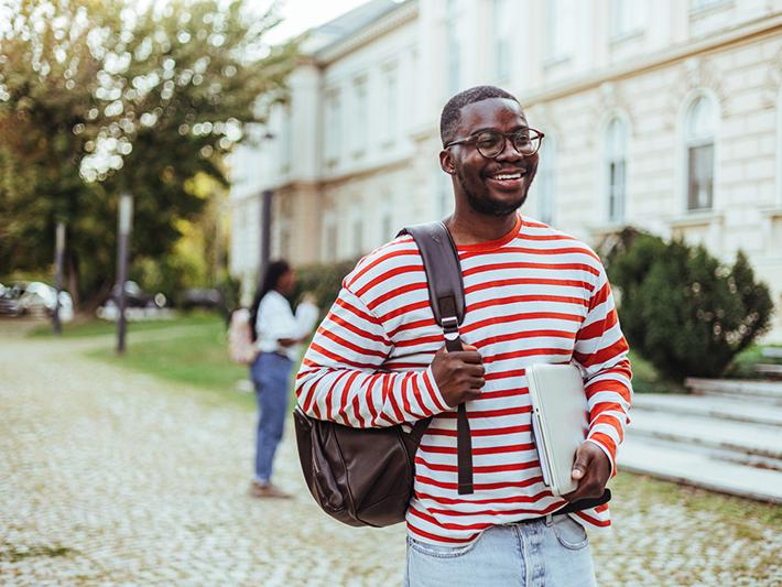 Young black male university student with a backpack