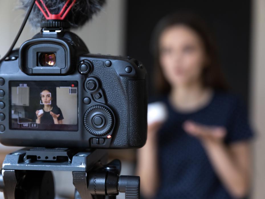 A teacher filming herself giving video feedback for her students