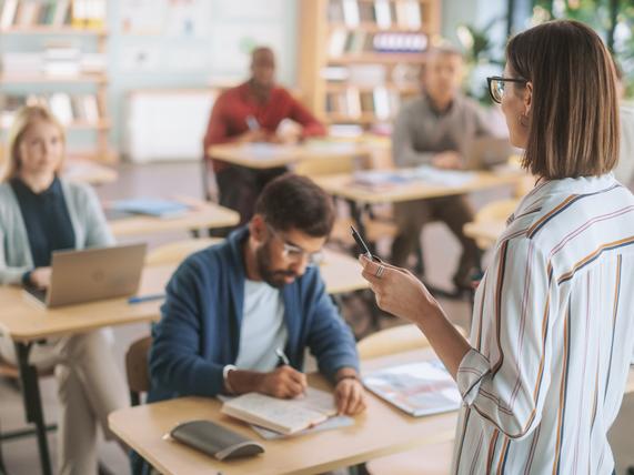 A teacher addresses a classroom of students