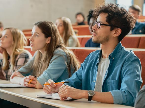 Students listen in a lecture hall 