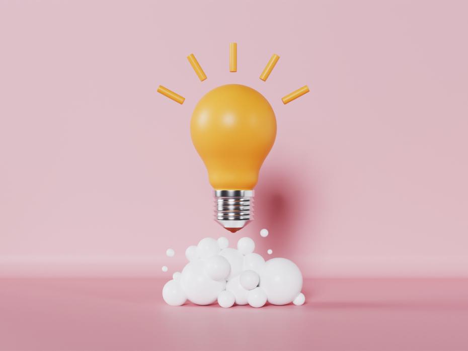 A lightbulb against a pink background