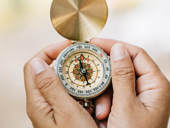 Hands holding a compass