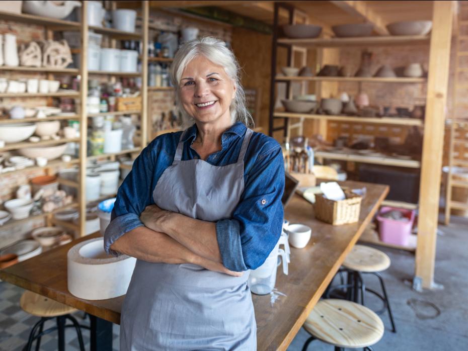 Female artist in her studio smiling to camera