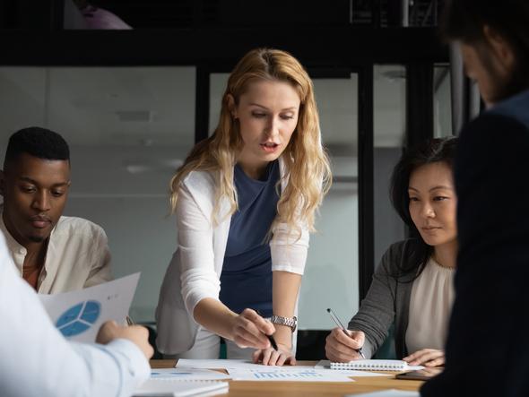 A group of people work around an office table