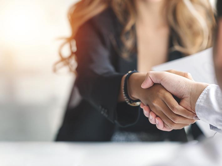 New hire shakes hands with hiring manager