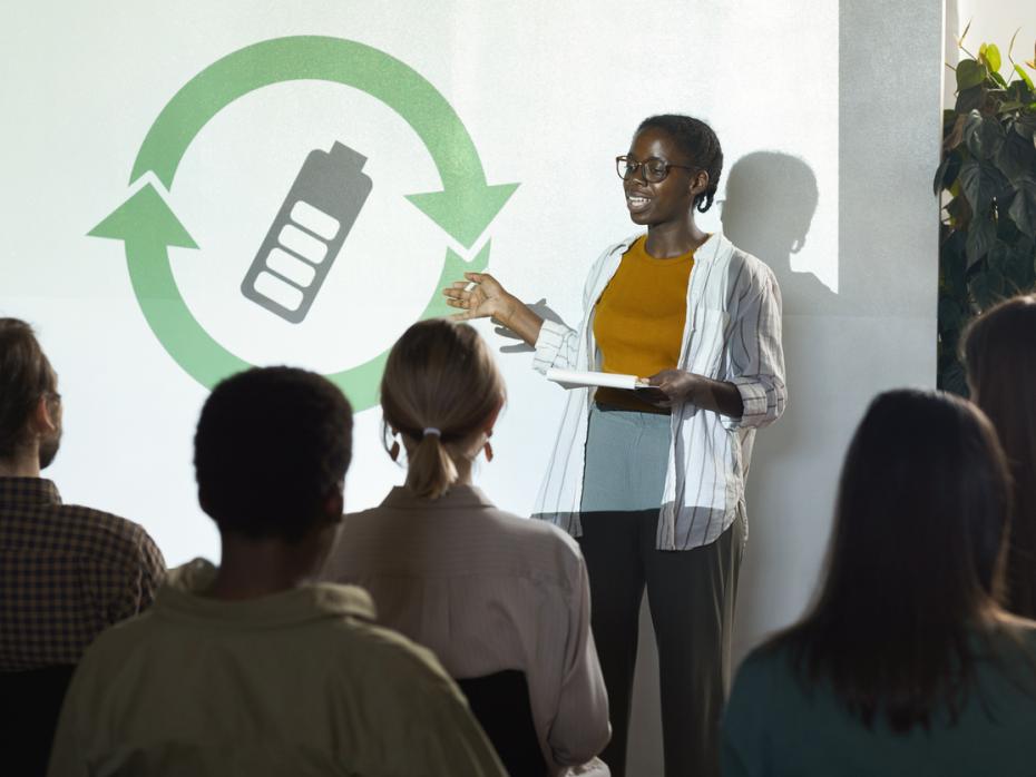 A student presenting a green initiative in front of an audience