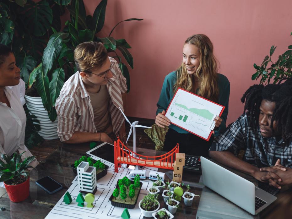 Group of students working on a modern urban architecture project with renewable green energy sources