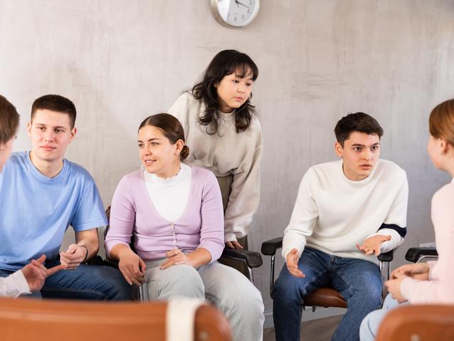 Students sit around in discussion