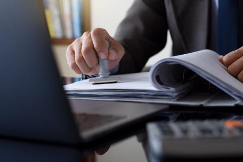 A patent document being stamped