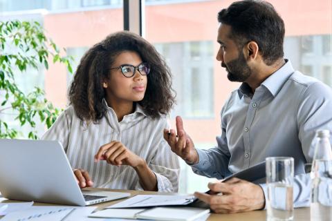 Young female student talks to an older coach or mentor