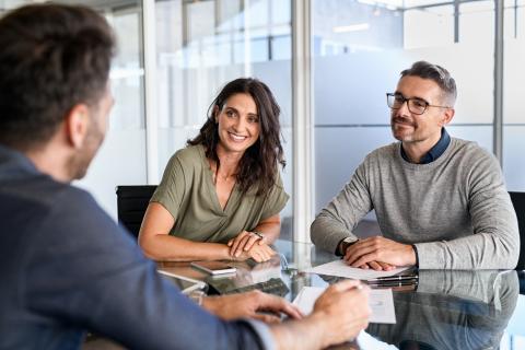 Three people in an office having a discussion