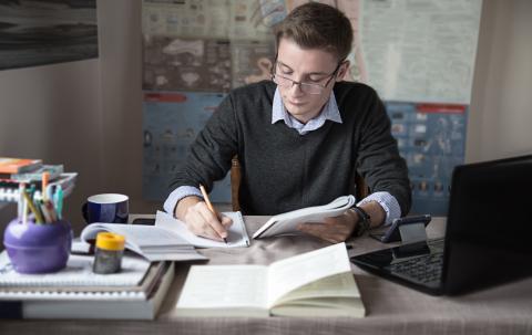 PhD student studying at his desk