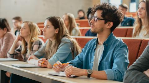 Students listen in a lecture hall 