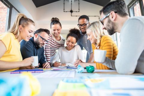 A group of people work round a table