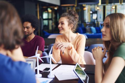 Young people in a meeting to discuss sustainability