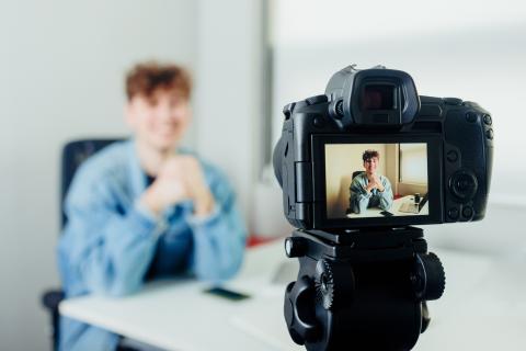 A student filming himself speaking to camera