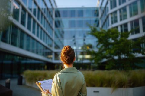 A woman surveys a building 