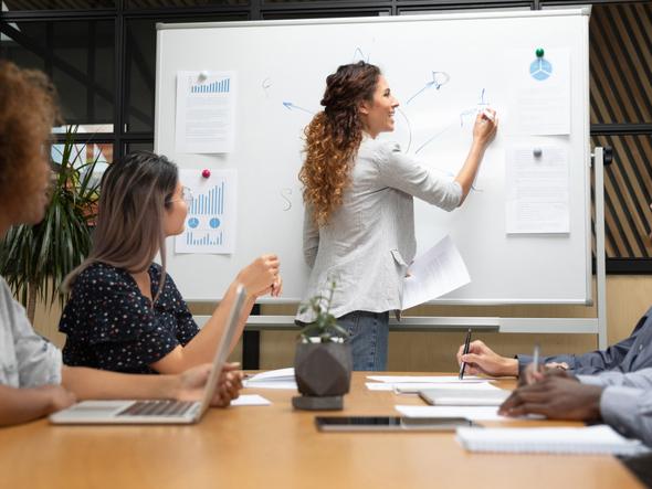 Woman writing on a whiteboard