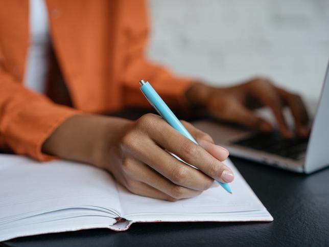 Black female student takes notes