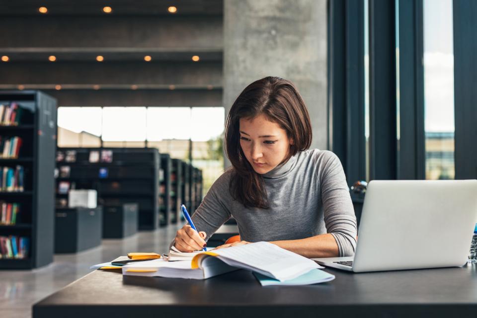 A young woman working in a library