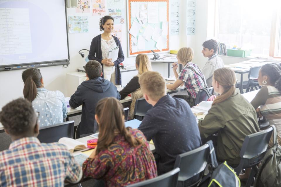 Teacher giving a class to a room full of students