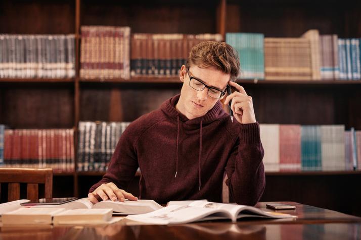 Male university student in library