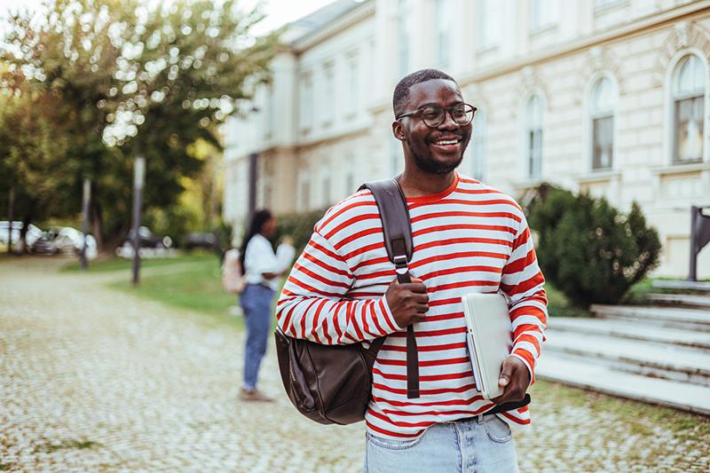 Young black male university student with a backpack