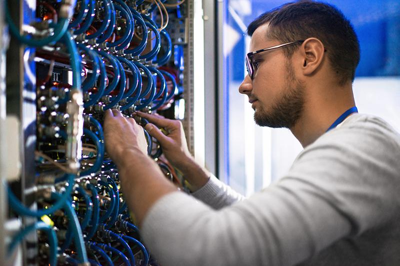 computer technician working on mainframe