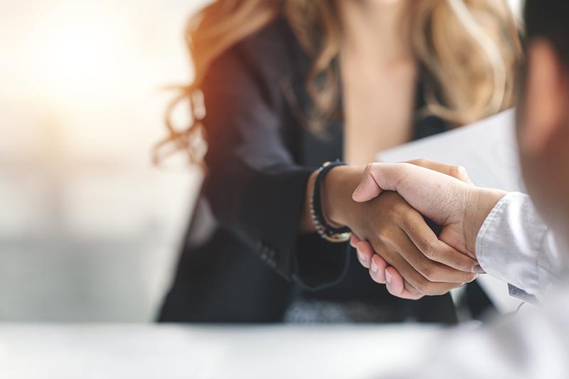 New hire shakes hands with hiring manager