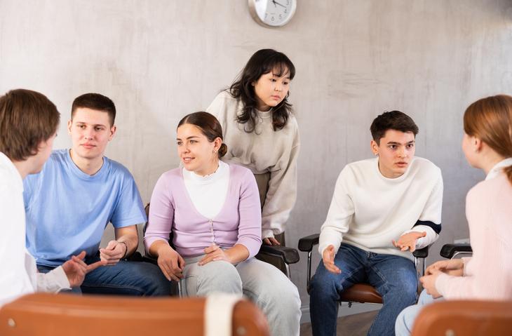 Students sit around in discussion