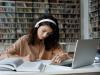 Female student writing in the university library