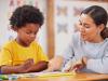 Young teacher working with child