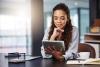 Buisiness woman using a tablet at her desk