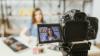 A filming set up of a female student speaking to camera