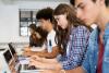 Students working at their laptops in class