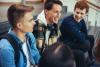 Three male students laughing and chatting